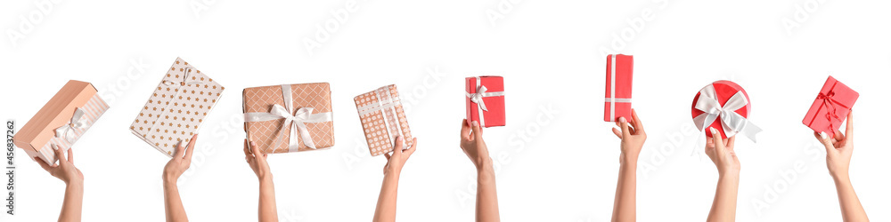 Wall mural female hands with gift boxes on white background