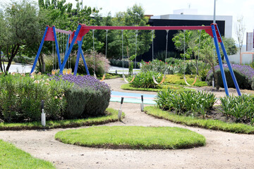 Color games for children in an open area between buildings, safe and quiet. There are swings, go up and down, slide and pass hands
