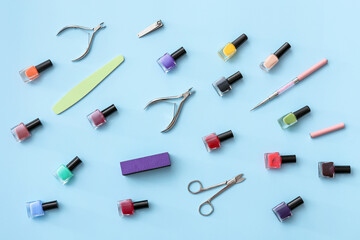 Set of tools for manicure and nail polishes on color background