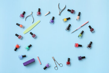 Frame made of tools for manicure and nail polishes on color background