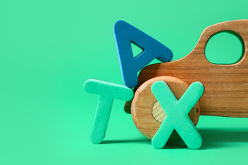 Word TAX with figure of car on color background