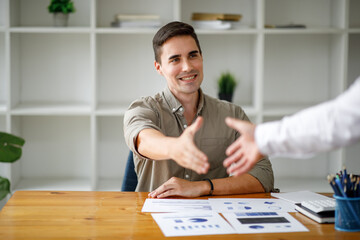 Business man offer and give hand for handshake in office. Successful job interview. Apply for loan...