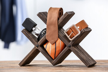 Stand with different stylish male accessories on table