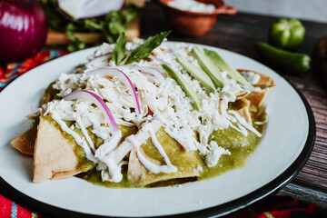 mexican chilaquiles with chicken and spicy green sauce traditional breakfast in Mexico