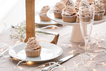 Tasty wedding cupcakes on table