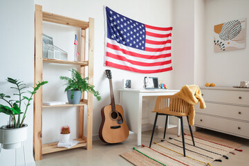 Interior of stylish room with modern workplace and USA flag