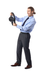 Young man with steering wheel on white background