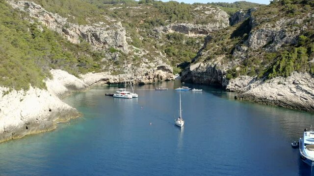 Stiniva Beach In Croatia - Luxury Yacht, Sailboat, And Catamaran Boat Anchored In Stiniva Bay. - aerial approach