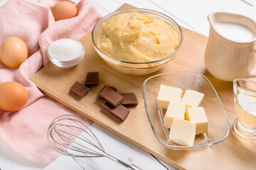 Ingredients for preparing churros on light wooden background