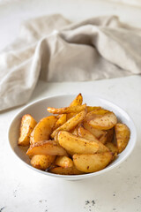 Bowl with tasty baked potato on table