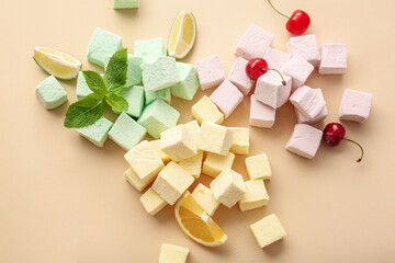 Tasty sweet marshmallows, fruits and mint on color background