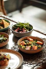 Table served with variety of different gourmet salad bowls