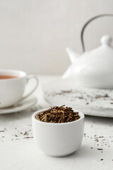 Bowl of dry hojicha green tea on table
