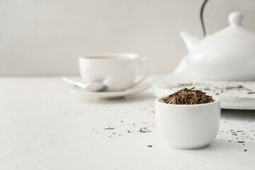 Bowl of dry hojicha green tea on table