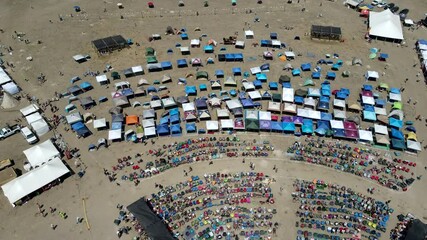 Cinematic drone flyover of patrons being entertained at a Music Festival in White Sulphur Springs, MT.