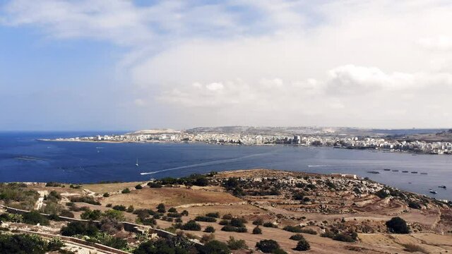 Nice aerial drone video from Malta, Mellieha, flying over Selmun with the view of Saint Paul's Bay and Bugibba of the opposite side of the bay.