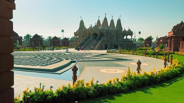 Panning right ground shot looking at the front of the BAPS Shri Swaminarayan Mandir Hindu temple in Chino California