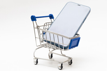mobile phone in a miniature shopping cart isolated on a white background  