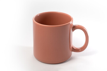 orange ceramic mug to use as a mockup. white background and copy space