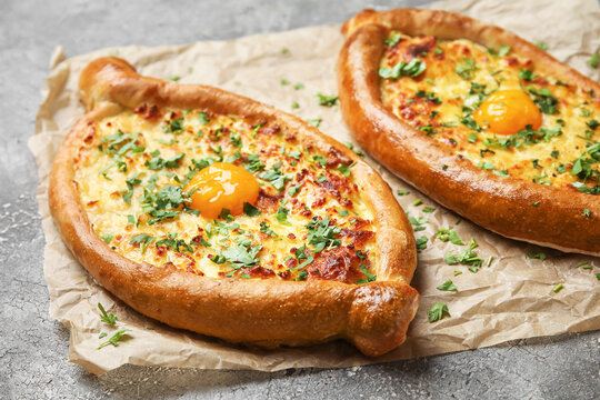 Tasty Ajarian khachapuri on grunge background