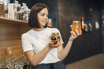 Beautiful woman in the store buys groceries.