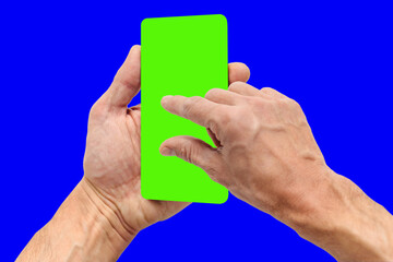Man holding mobile phone with chroma key screen and touching to zoom display, hand of a young man with protruding veins, the device is positioned slightly turned