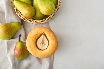 Tasty pear pot pie and basket with fresh fruits on light background