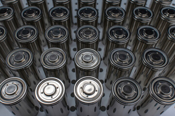 A pack of new modern high-capacity lithium-ion cells. A prototype of new batteries on a laboratory table.
