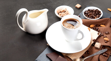 Coffee with snacks on black background.