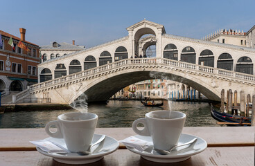 coffee for two in front of the Rialto bridge in Venice - steaming cups