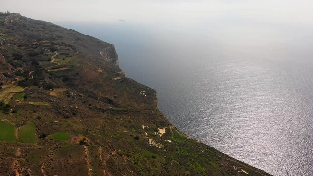 Impressive aerial video from west of Malta, Dingli area turning from the land towards the steep and high cliffs.