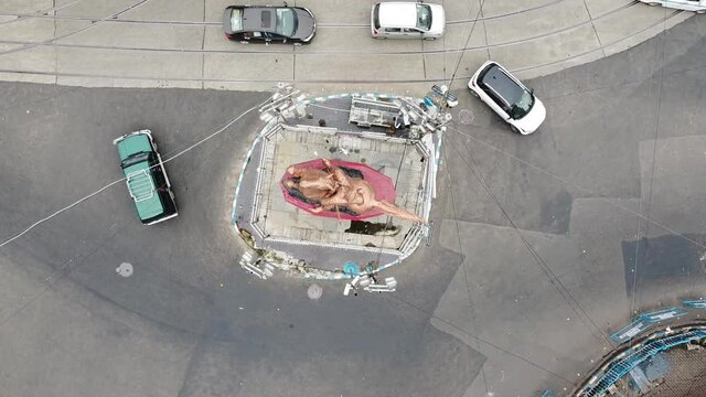 Aerial shot of Shyambajar crossing with Netaji Subhash Chandra Bose statue in the middle with car, yellow taxi crossing from the tram lines. Shyambazar char matha more drone shot.