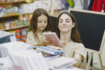 Family choosing school stationery in the supermarket