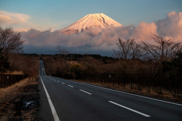 A straight road leading to the top of Mt. Fuji floating above the clouds A