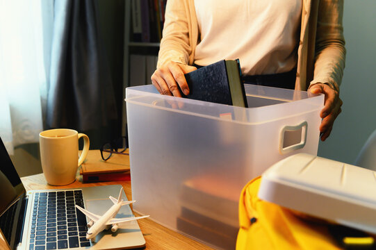 Female Student Abroad Keep The Book In Plastic Box And Backpack With Laptop On Desk At Home To Prepare For The Journey To Go Back To Study At University.