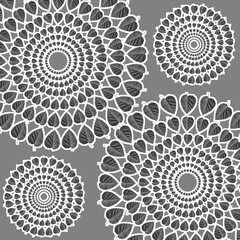 A trendy abstract black and white pattern of circles and mulberry leaves.