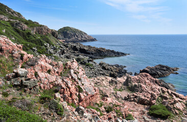 Scenic landscape in the Kullaberg Nature Reserve, Mölle, Skåne, Sweden. Red rocks, summery blue...