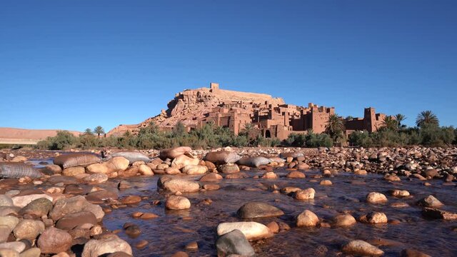 Water Flowing At Asif Ounila River With Ait Benhaddou In The Background In Morocco. - wide static