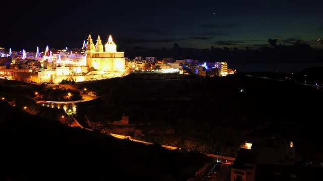 Impressive turning timelapse video from Malta, Mellieha, with the lit up and decorated Parish Church at night.