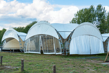 Assembly and installation of a large tent made of a metal frame and polymer fabric for outdoor events.