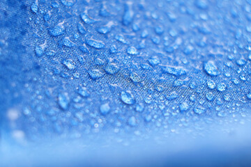 Water drops on the fabric. Rain Water droplets on blue fiber waterproof fabric. Water drops pattern...