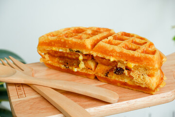 Delicious waffles on the wooden plate at garden.