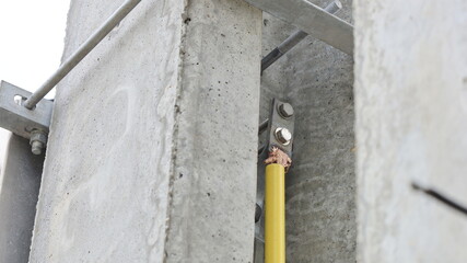 Close-up of ground wires on high voltage poles. Bolt with copper wire of ground wire on concrete pole. Selective focus