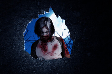 Wall hole with a scary zombie standing