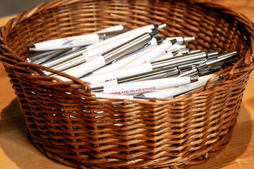 A basket with many pens