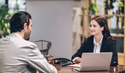 female lawyer smiles and gives legal advice to clients who come to consult