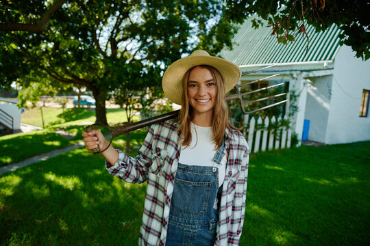Caucasian female farmer standing in front of farm house ready to work 