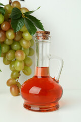 Concept of grape vinegar on white background