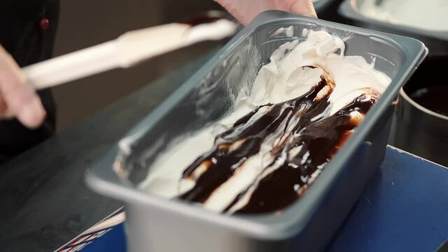 Man making gelato ice cream in professional kitchen