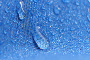 water beading on fabric. Waterproof coating background with water drops
